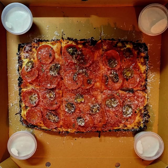 Detroit style pepperoni pan pizza with dips