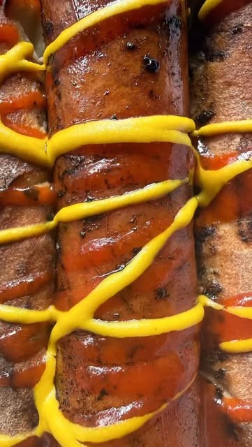 Hot dog with mustard and hot sauce at Inn Deep